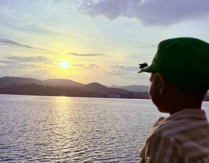 Child watching a warm sunset, unhurried